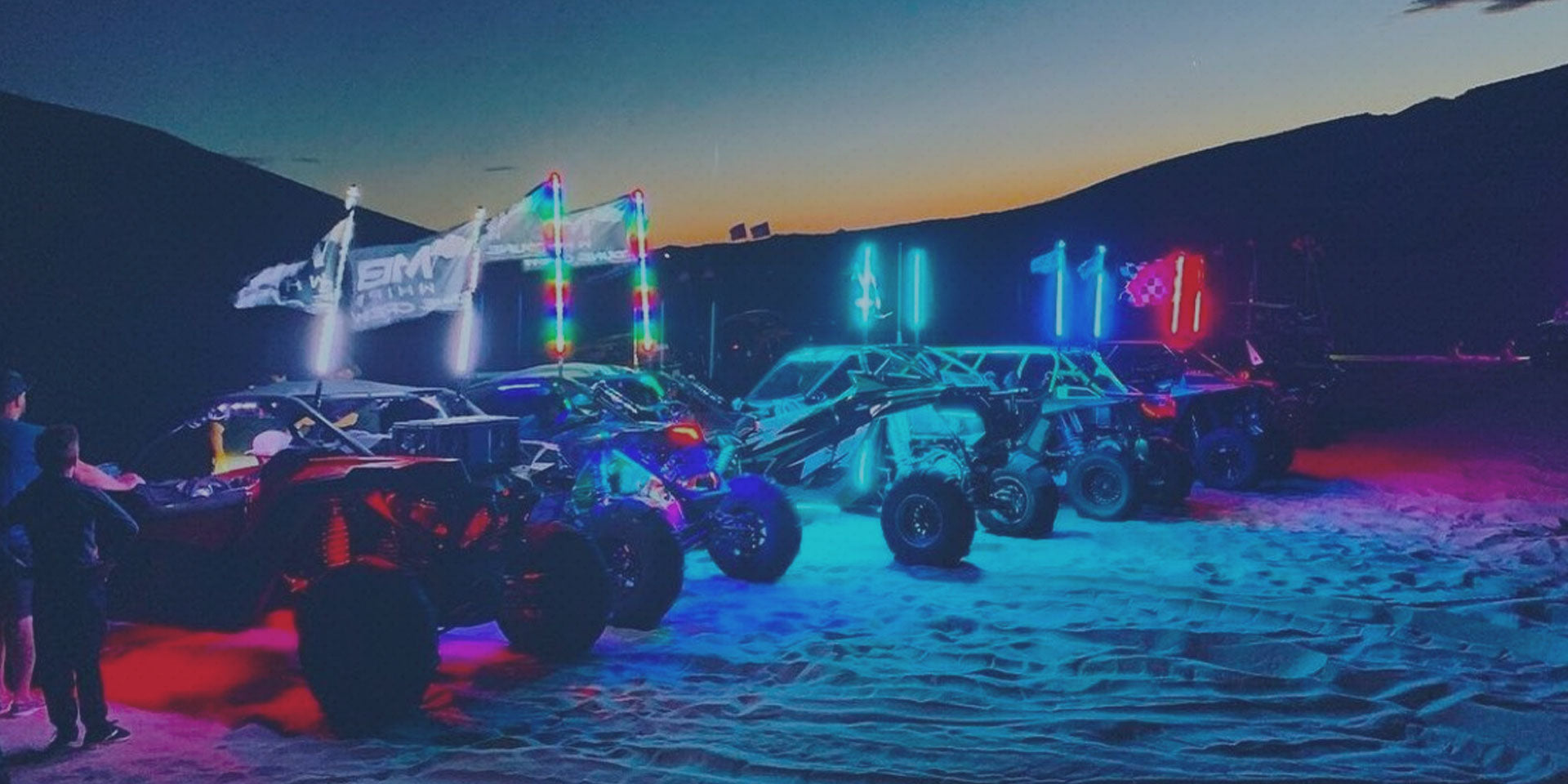 UTV's at the sand dunes with MB Whips LED lighted flags. 