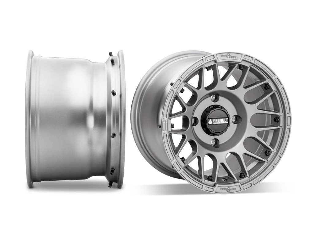 assault utv wheel 10 inch wide titanium gray side shot sitting next to forward facing shot on white background 