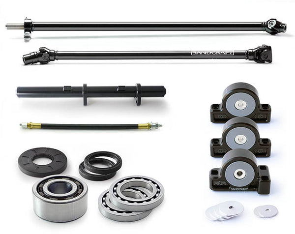 sandcraft complete drivetrain solution kit for turbo s 4 seater with driveline and carrier bearing on top motor mount tube and carrier bearing grease whip in the middle front diff bearing and seal kit on the bottom and billet motor mounts on the right all sitting on a white background 